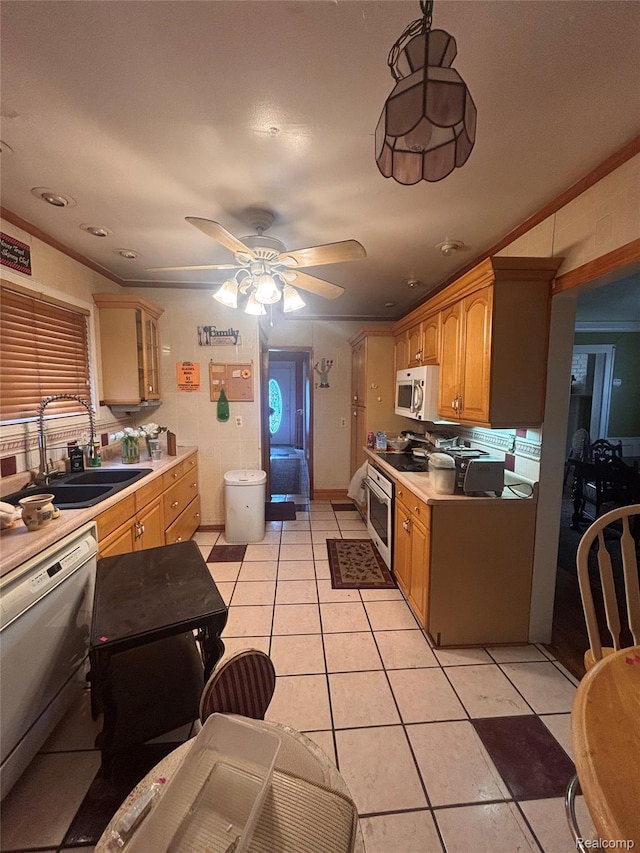 2036 Collingwood St, Detroit, MI 48206 - kitchen featuring white microwave, dishwashing machine, a sink, light tile patterned flooring, and light countertops