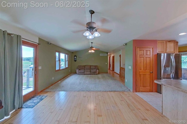3749 Chase Lake Rd, Howell, MI 48855 - unfurnished living room featuring a ceiling fan, light wood-style flooring, baseboards, and vaulted ceiling