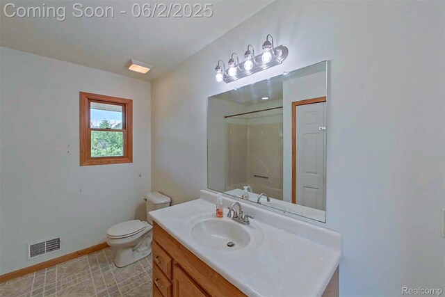 3749 Chase Lake Rd, Howell, MI 48855 - bathroom with vanity, toilet, a shower, and baseboards