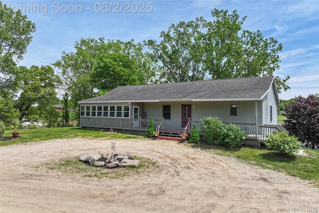 3749 Chase Lake Rd, Howell, MI 48855 - single story home with a shingled roof, an outdoor fire pit, driveway, and a wooden deck