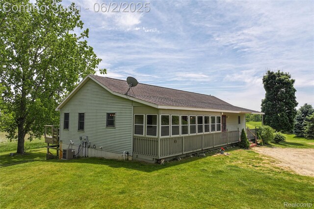 3749 Chase Lake Rd, Howell, MI 48855 - view of property exterior featuring central air condition unit, a yard, and roof with shingles