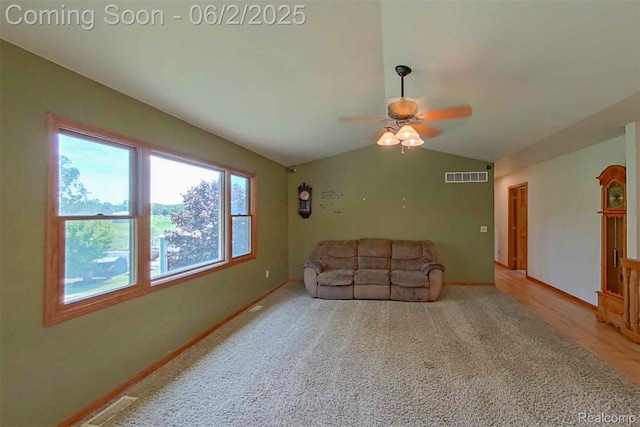 3749 Chase Lake Rd, Howell, MI 48855 - unfurnished living room featuring vaulted ceiling, a ceiling fan, and baseboards