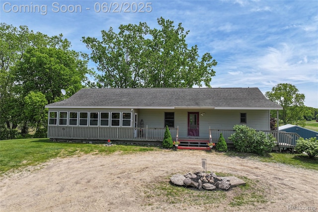 3749 Chase Lake Rd, Howell, MI 48855 - view of front of home featuring a shingled roof, a deck, and a fire pit
