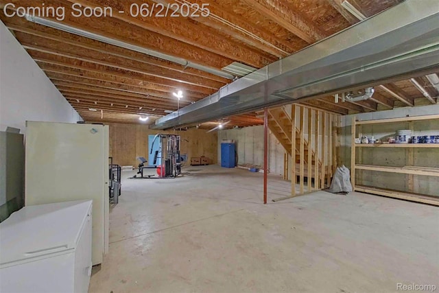 3749 Chase Lake Rd, Howell, MI 48855 - unfinished below grade area with freestanding refrigerator and stairs