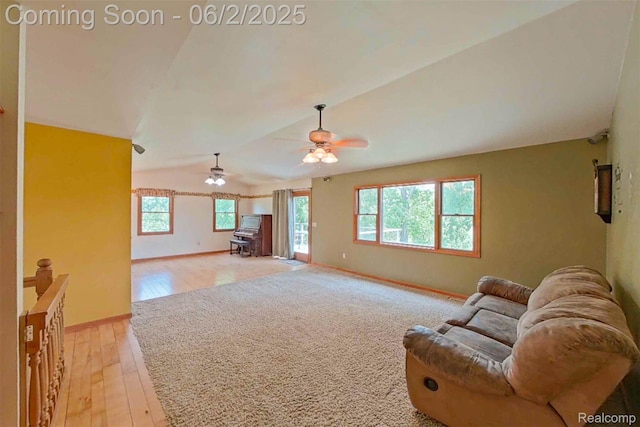 3749 Chase Lake Rd, Howell, MI 48855 - living area featuring lofted ceiling, light wood-type flooring, a wood stove, baseboards, and ceiling fan