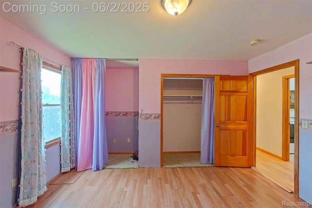 3749 Chase Lake Rd, Howell, MI 48855 - unfurnished bedroom featuring wood finished floors, baseboards, and a closet