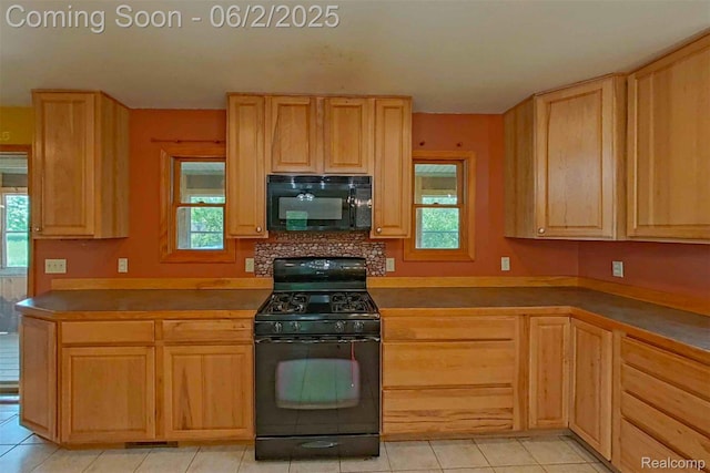 3749 Chase Lake Rd, Howell, MI 48855 - kitchen featuring black appliances, light brown cabinets, and plenty of natural light