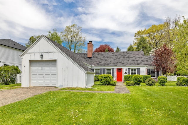 view of front of property with board and batten siding, a chimney, driveway, and an attached garage