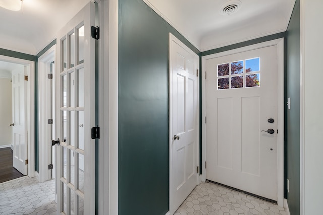 entryway featuring light tile patterned floors and baseboards
