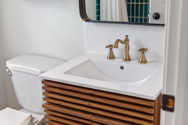bathroom featuring toilet and vanity