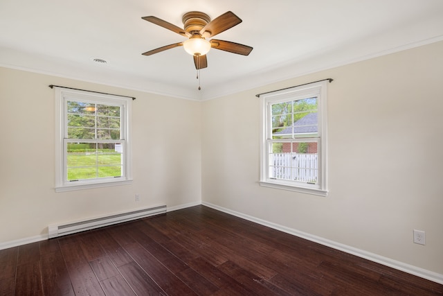 spare room with a baseboard heating unit, ceiling fan, dark wood-type flooring, baseboards, and ornamental molding
