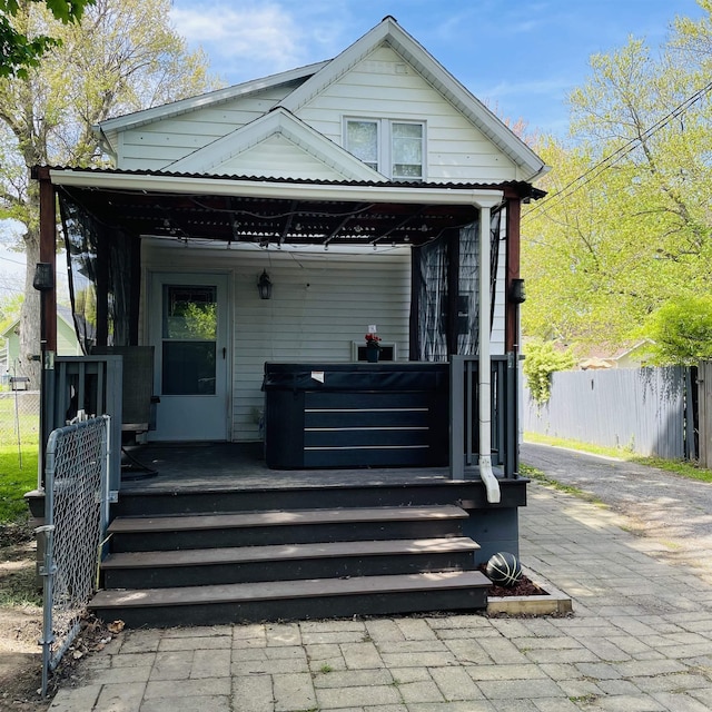 326 N Oak St, Owosso, MI 48867 - view of front of house featuring fence and a wooden deck