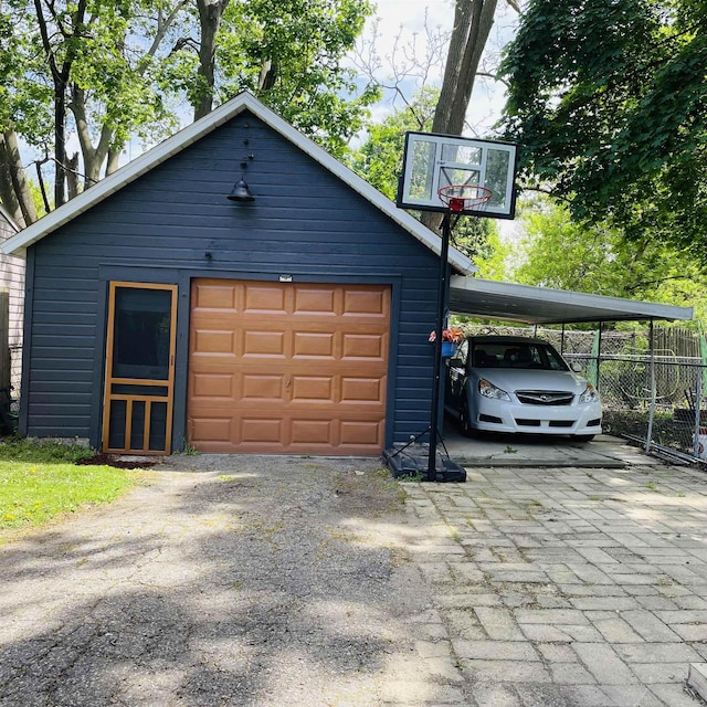 326 N Oak St, Owosso, MI 48867 - garage featuring fence and driveway