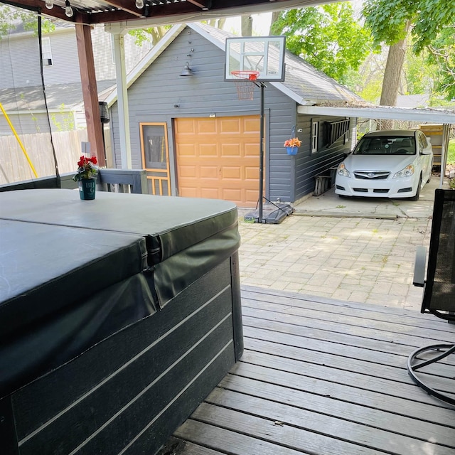 326 N Oak St, Owosso, MI 48867 - deck featuring an outdoor structure, a garage, a hot tub, and driveway