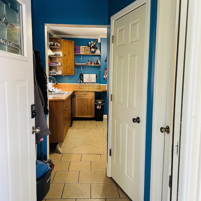 326 N Oak St, Owosso, MI 48867 - laundry area with a sink and light tile patterned floors