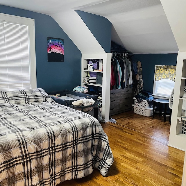 326 N Oak St, Owosso, MI 48867 - bedroom with wood finished floors, vaulted ceiling, and a closet