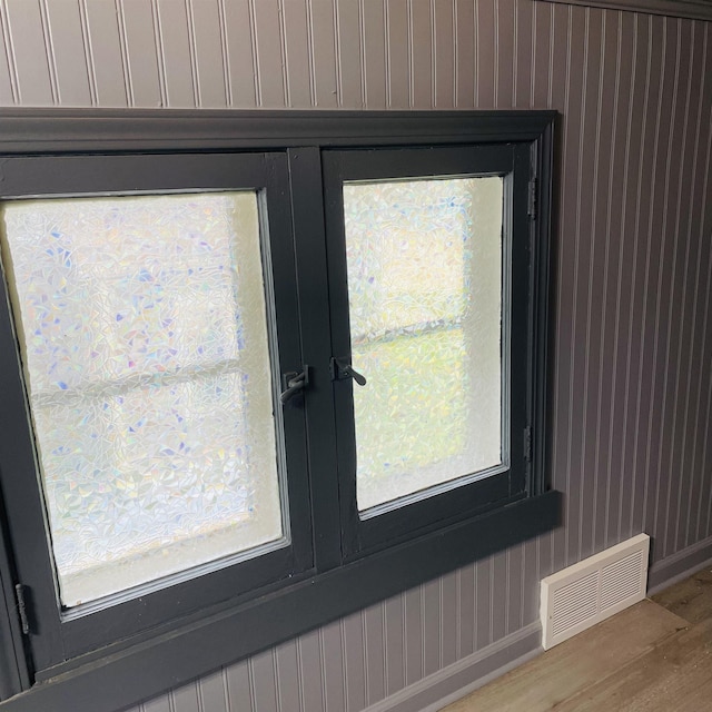 326 N Oak St, Owosso, MI 48867 - detailed view of french doors, wood finished floors, and baseboards