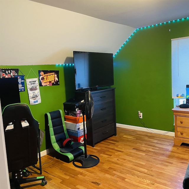 326 N Oak St, Owosso, MI 48867 - playroom featuring light wood-style flooring, baseboards, vaulted ceiling, and a desk