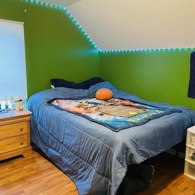 326 N Oak St, Owosso, MI 48867 - bedroom featuring wood finished floors and vaulted ceiling