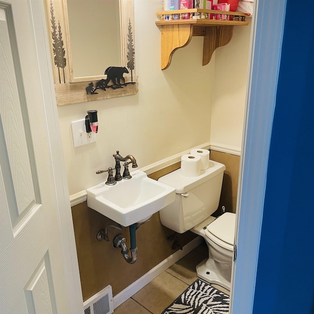 326 N Oak St, Owosso, MI 48867 - bathroom with toilet, tile patterned floors, and a sink