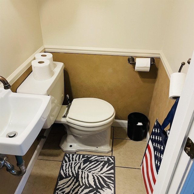 326 N Oak St, Owosso, MI 48867 - bathroom featuring toilet, a sink, tile patterned floors, and baseboards