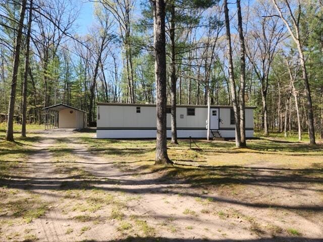 1631 W Lone Pine Rd, Baldwin, MI 49304 - manufactured / mobile home featuring an outdoor structure and a carport