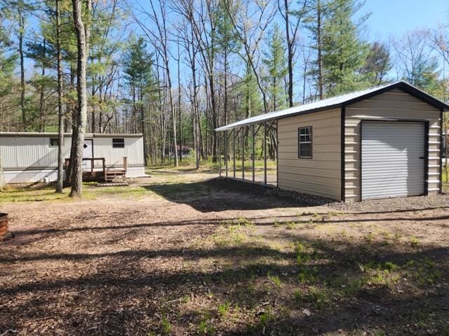 1631 W Lone Pine Rd, Baldwin, MI 49304 - view of yard featuring an outbuilding and a carport