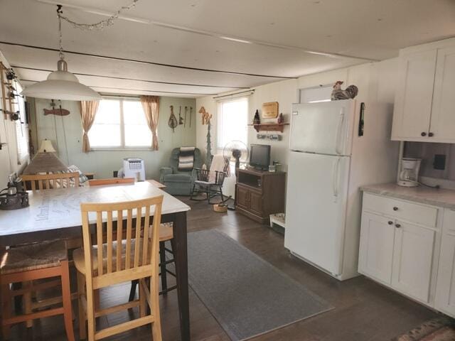 1631 W Lone Pine Rd, Baldwin, MI 49304 - dining area featuring dark wood-style flooring