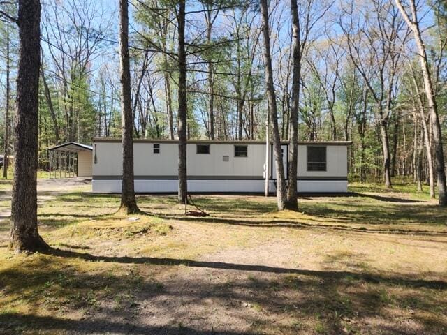1631 W Lone Pine Rd, Baldwin, MI 49304 - view of front of house with a carport and a front lawn
