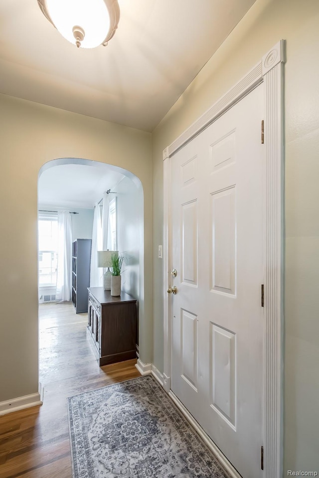3070 Old Orchard Dr, Waterford, MI 48328 - entryway featuring arched walkways, wood finished floors, and baseboards