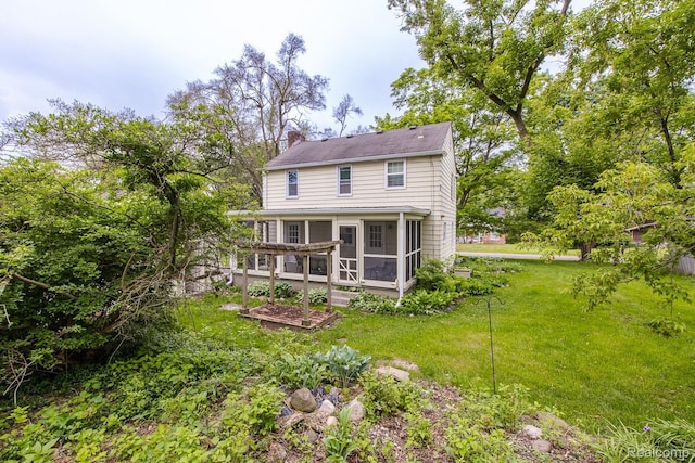 3070 Old Orchard Dr, Waterford, MI 48328 - rear view of property featuring a chimney, a sunroom, and a yard