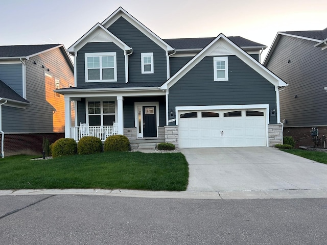 31065 Tremont Ln, Franklin, MI 48025 - view of front facade with a porch, concrete driveway, a front yard, and stone siding