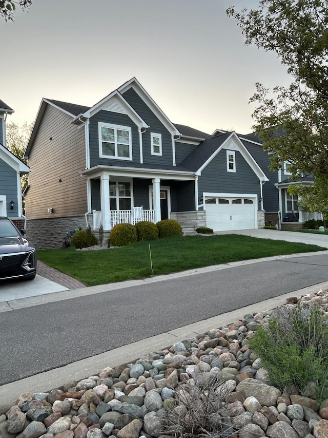 31065 Tremont Ln, Franklin, MI 48025 - craftsman inspired home featuring covered porch, stone siding, driveway, and a garage