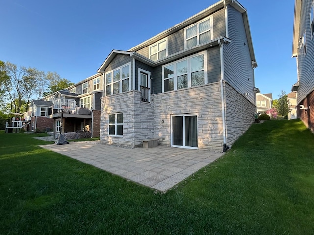 31065 Tremont Ln, Franklin, MI 48025 - rear view of house with stone siding, a lawn, and a patio