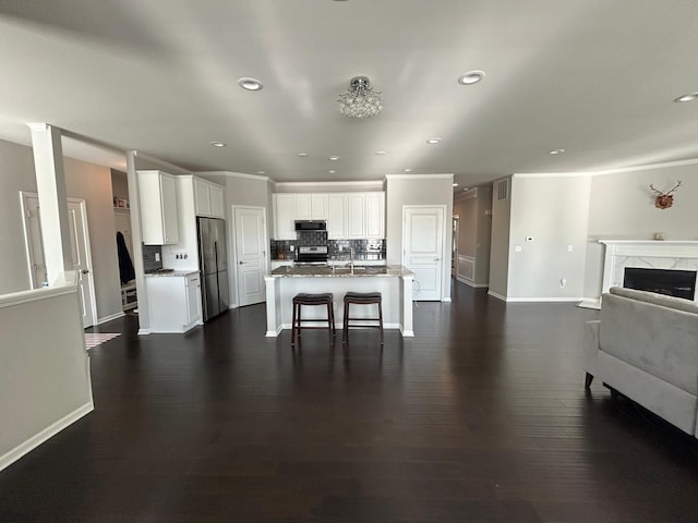 31065 Tremont Ln, Franklin, MI 48025 - kitchen with appliances with stainless steel finishes, open floor plan, baseboards, decorative backsplash, and recessed lighting