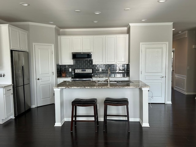 31065 Tremont Ln, Franklin, MI 48025 - kitchen featuring stainless steel appliances, a sink, ornamental molding, light stone countertops, and decorative backsplash