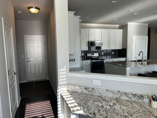 31065 Tremont Ln, Franklin, MI 48025 - kitchen with stainless steel appliances, a sink, white cabinets, light stone counters, and backsplash