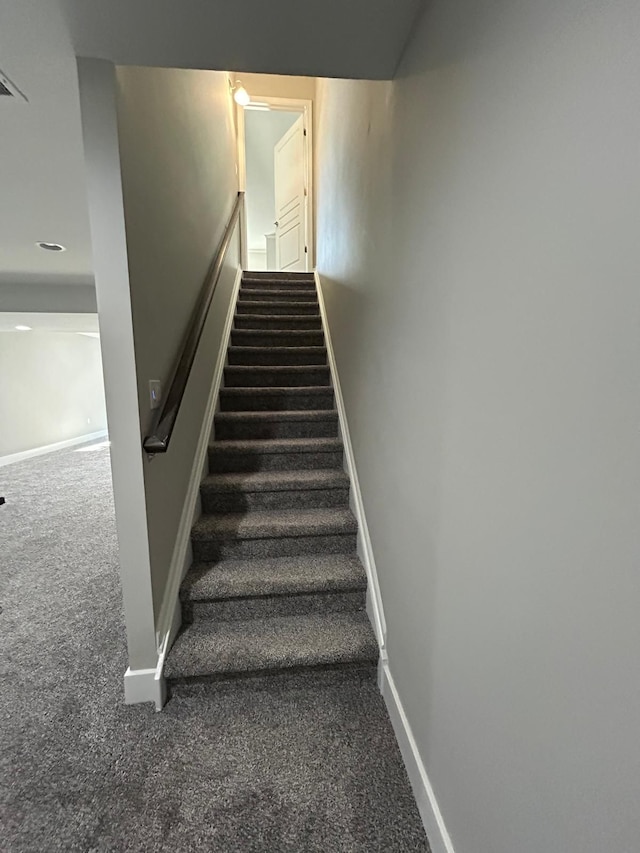 31065 Tremont Ln, Franklin, MI 48025 - stairway featuring carpet floors and baseboards