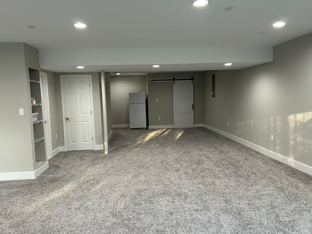 31065 Tremont Ln, Franklin, MI 48025 - finished basement featuring freestanding refrigerator, a barn door, recessed lighting, carpet, and baseboards