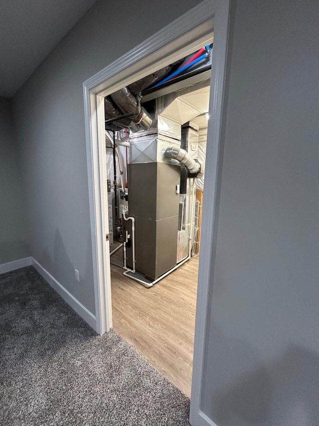 31065 Tremont Ln, Franklin, MI 48025 - hallway with heating unit, baseboards, and carpet flooring