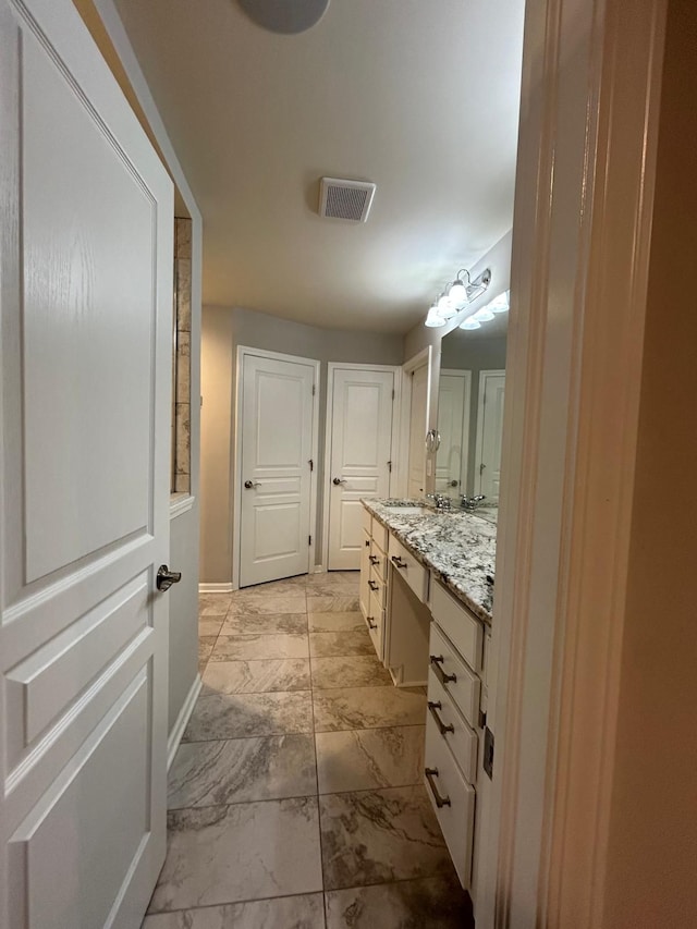 31065 Tremont Ln, Franklin, MI 48025 - bathroom featuring marble look tiles, baseboards, and vanity