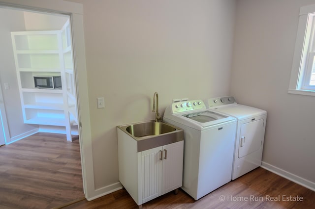 laundry room featuring washer and clothes dryer, dark wood-style floors, baseboards, and cabinet space
