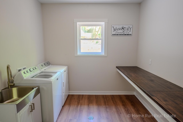 clothes washing area featuring washer and clothes dryer, cabinet space, dark wood-type flooring, and baseboards