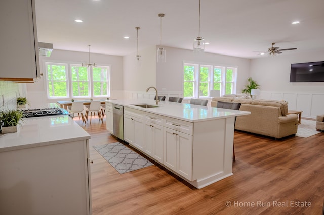 8828 Division Ave S, Byron Center, MI 49315 - kitchen with a sink, dishwasher, light countertops, white cabinetry, and light wood-type flooring
