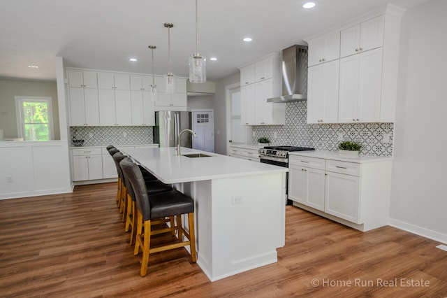 8828 Division Ave S, Byron Center, MI 49315 - kitchen featuring wall chimney range hood, stainless steel appliances, a sink, backsplash, and recessed lighting