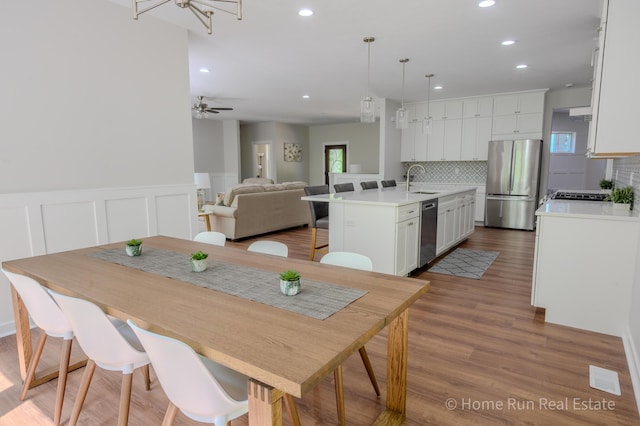 8828 Division Ave S, Byron Center, MI 49315 - dining space with recessed lighting, wood finished floors, a ceiling fan, and wainscoting