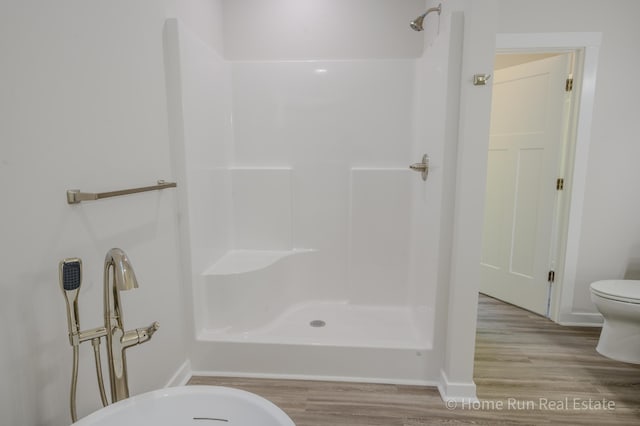 8828 Division Ave S, Byron Center, MI 49315 - full bathroom featuring wood finished floors, a walk in shower, toilet, and baseboards