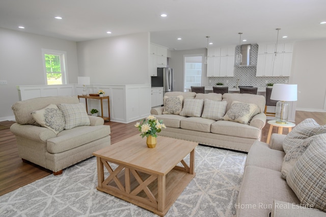8828 Division Ave S, Byron Center, MI 49315 - living area featuring light wood-type flooring, recessed lighting, and a wainscoted wall