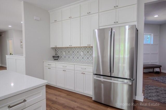 8828 Division Ave S, Byron Center, MI 49315 - kitchen with freestanding refrigerator, wood finished floors, backsplash, light countertops, and recessed lighting
