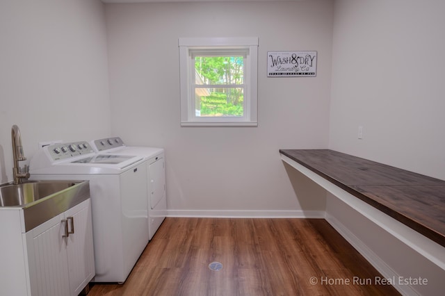 8828 Division Ave S, Byron Center, MI 49315 - washroom with independent washer and dryer, cabinet space, wood finished floors, and baseboards